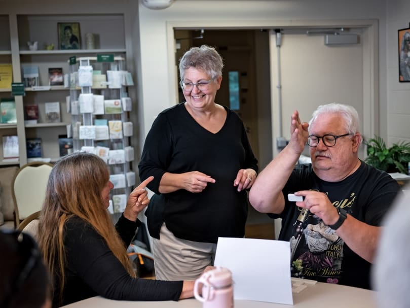 Lulu Lee, center, facilitates during a team-building exercise during the 2022 National Deaf Cursillo held at Ignatius House Jesuit Retreat Center in Sandy Springs. Lee is the lay director for the Cursillo for the Deaf community. Photo by Johnathon Kelso