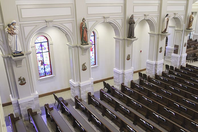 (L-r) Statues of Blessed Mother Teresa, St. Jude, St. Padre Pio, St. Therese of Lisieux and St. Peter are displayed above the pews on the left side of the church. On the right side of the church are five other statues including St. Elizabeth Ann Seton, St. Vincent de Paul, St. Anthony of Padua, St. Kateri Tekakwitha and St. John Paul II. Photo By Michael Alexander