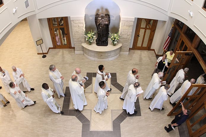 Clergy process through the narthex into the nave of the church. A statue of St. Michael the Archangel serves as a centerpiece in the new churchâs narthex. Photo By Michael Alexander