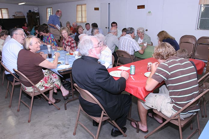The Sunday afternoon potluck lunch is a weekly event following 11:30 Mass. Photo By Michael Alexander