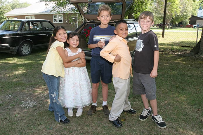 (L-r) Deybram and Shamila Gonzalez, cousins, Elyjah Collier, Victor Martinez and Zachary Freeman play outside after Mass. Photo By Michael Alexander