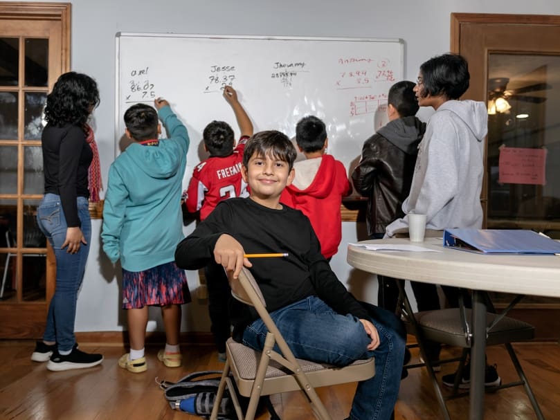 Sebastian Gonzalez, center, participates in an after-school program at St. Brendan the Navigator. The program is a partnership with Next Generation Focus, a nonprofit which helps to tutor and mentor students in greater Atlanta. Photo by Johnathon Kelso