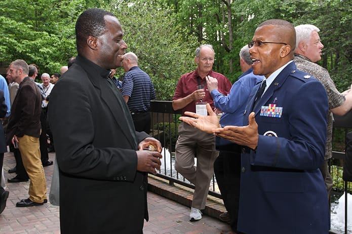 Father Godfred Boachie-Yiadom, left, parochial vicar at St. Joseph Church, Macon, and Father Laserian Nwoga, a U.S. Air Force chaplain stationed at Randolph Air Force Base in Texas, find a moment for fellowship during the NFPC reception. Photo By Michael Alexander