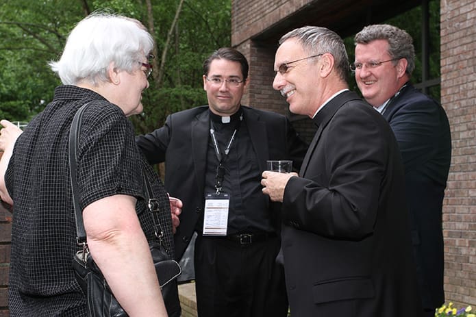 Bishop Luis Zarama of Atlanta, near right, speaks with Franciscan Sister Dorothy Heiderscheit, the CEO of Southdown Institute, a Toronto, Canada based facility addressing the needs of religious and clergy around addictions and mental health issues. Looking on from the background are Father John Guthrie, left, associate director of the USCCB’s Secretariat for Clergy, Consecrated Life and Vocations, and Gerard O’Connor of the St. John Vianney Center, a Downingtown, Pa., facility that treats behavioral health and addictive diseases for Catholic clergy, women religious and other Christian denominations. Photo By Michael Alexander