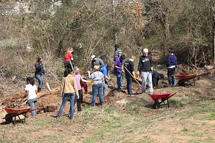 University of Georgia students participate in a March beautification project on the grounds of Oasis CatÃ³lico Santa Rafaela, inside the Pinewood Estates North mobile home community, Athens. Some of the students are members of Project Hope, a student organization that works to help the trailer community. Photo By Michael Alexander