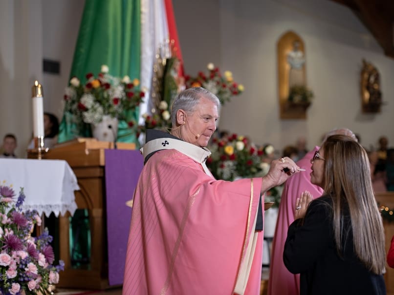 Archbishop Gregory J. Hartmayer, OFM Conv., administers holy Communion to the faithful during a Mass at St. Oliver Plunkett Church on the third Sunday of Advent. The parish marked the Feast of Our Lady of Guadalupe with special events the same weekend. Photo by Johnathon Kelso
