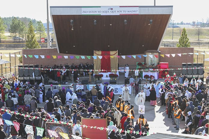 Father Paul Williams, pastor of St. Joseph Church, Dalton, and parochial vicars Father Jose Duvan Gonzalez and Father Timothy E. Nadolski distribute holy Communion to the vast crowd on hand for the Mass celebrated in conjunction with the Dec. 10 Our Lady of Guadalupe festival at Heritage Point Park. Photo By Michael Alexander