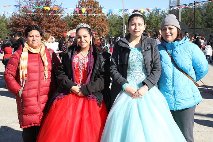 (L-r) Marcela Olvera stands with her daughter Jazmin and Michelle Manzano stands with her mother Liliana during the cultural celebration that followed the Mass. Jazmin and Michelle, who turned 15-years-old Aug. 6 and July 23, respectively, walked in the procession with other females who also celebrated their quinceañera in 2016. Photo By Michael Alexander