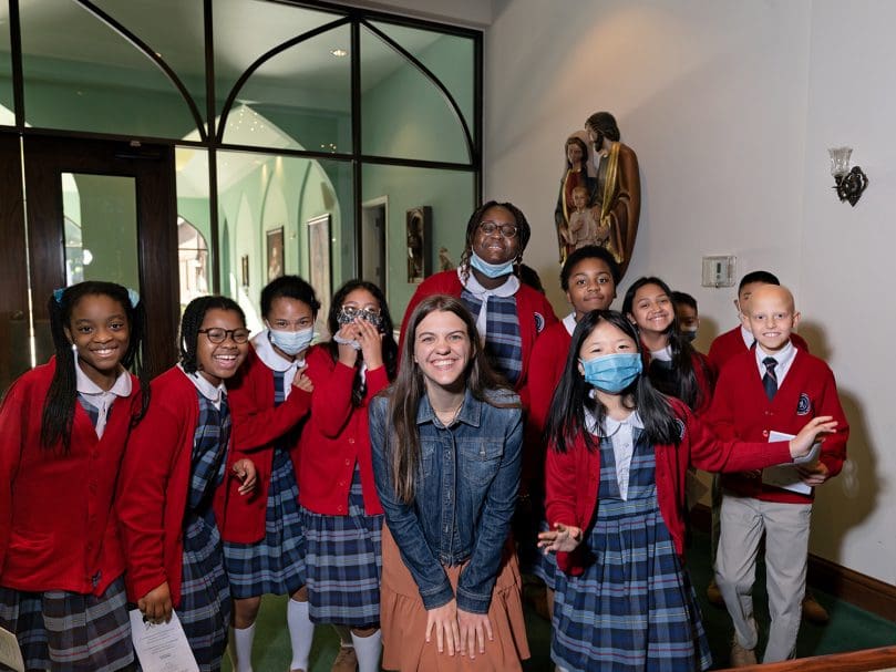 Substitute teacher Mary Garger is seen with her students before the last school Mass for Our Lady of Victory School. Photo by Johnathon Kelso