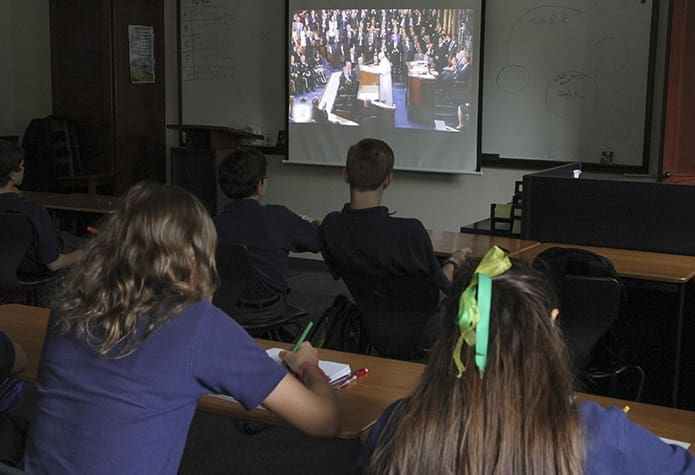 Students in Thomas Clement’s eighth-grade theology class at Holy Spirit Preparatory School, Atlanta, watch Pope Francis address the joint session of the United States Congress Sept. 24. Photo By Michael Alexander