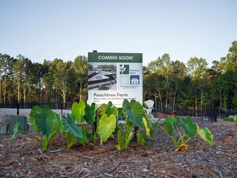 A sign marks the land leading to Peachtree Farm, an equitable employment farm for adults with disabilities. The nonprofit is located in Peachtree Corners. Photo by Johnathon Kelso