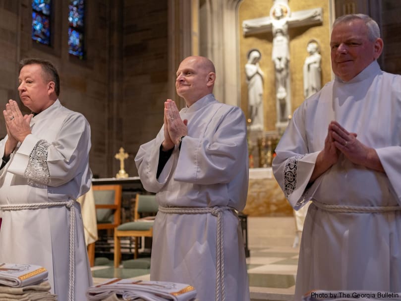 Candidates for the permanent diaconate turn to face the congregation during the Mass of ordination Feb. 3 at the Cathedral of Christ the King. From left to right are William Hardeman Schubring, Michael Patrick Martell and Michael Heubel. Photo by Johnathon Kelso