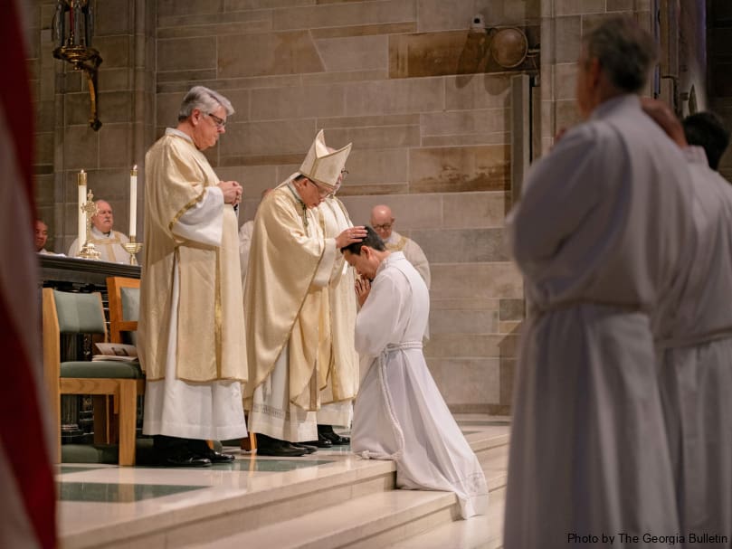 BishopJohn Nhan Tran lays his hands on candidate Phillip Tran during the Mass of ordination to the permanent diaconate Feb. 3 at the Cathedral of Christ the King.