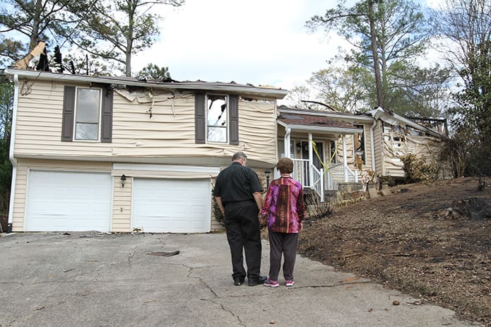 The Kellers, who have been married for 48 years, observe what’s left of their home, but their thoughts and prayers are with the pilot who lost his life and his family. Photo By Michael Alexander