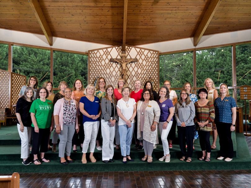 Parish preschool administrators join Mary Jo Nichols, front row center, for a group photo in the sanctuary at Holy Family Church during the Preschool Summer Institute. Nichols is director of the Parish Preschool Program for the Archdiocese of Atlanta. Photo by Johnathon Kelso
