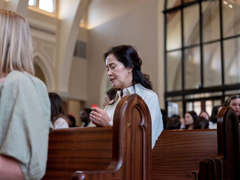 A woman prays before the ordination Mass at Holy Vietnamese Martyrs Church. Five new priests were ordained. Photo by Johnathon Kelso