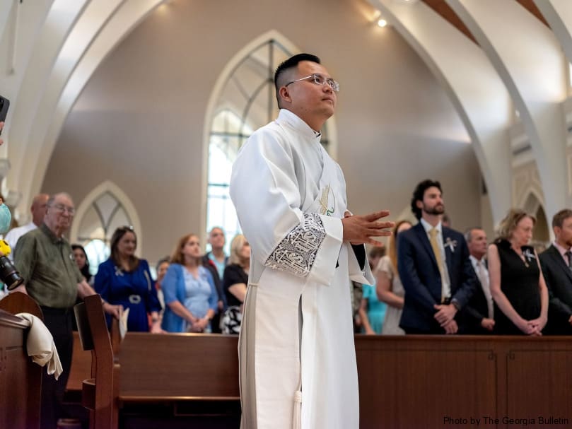 Deacon Joseph Nguyen stands during the presentation of the candidates during the ordination to the priesthood held at Holy Vietnamese Martyrs Church. Photo by Johnathon Kelso
