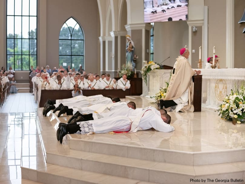 The candidates lay prostrate during the litany of supplication of the ordination held in Norcoss June 1. Photo by Johnathon Kelso