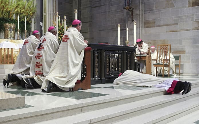 During the Litany of Supplication at his episcopal ordination, Bishop-designate Bernard E. (Ned) Shlesinger III prostrates himself before the altar at the Cathedral of Christ the King, as the congregation kneels with clergy in prayer. Photo By Michael Alexander