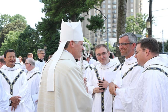Bishop Bernard E. (Ned) Shlesinger III, left center, stops to greet some former colleagues and friends. They include (l-r) Father Sean Bransfield, formerly the dean of men for the Saint Charles Borromeo Seminary College Division, Wynnewood, Pa., and currently assistant to the Vicar for Clergy for the Archdiocese of Philadelphia, Father Christopher Cooke, director of the Saint Charles Borromeo Seminary spiritual year program, and Father Matthew Zuberbueler, pastor of St. Anthony of Padua Church, Falls Church, Va. Photo By Michael Alexander