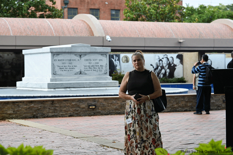 Tammi Murray, in town with Catholic Mobilizing Network for the restorative justice conference, stands in front of Dr. and Mrs. King’s Crypt at the King Center in Atlanta. Photo by Julianna Leopold