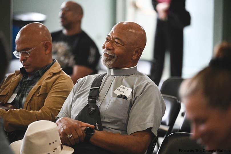 Deacon Al Turner, of St. Paul of the Cross Church in Atlanta, listens to a program about the rich history of Ebenezer Baptist Church to kick off the first day of the National Catholic Conference on Restorative Justice Sept. 25. The conference aimed to “advance healing approaches to harm, crime, and injustice.” Photo by Julianna Leopold 