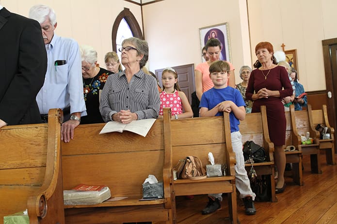 St. Katharine Drexel is a mission of 45 families. Ten-year-old Laurie Collier, left center, and her 8-year-old brother Abraham makeup some of its younger members. Laurie is three weeks younger than the mission. Photo By Michael Alexander