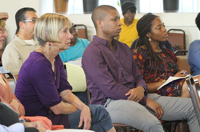 (Foreground, l-r) Susan Taquechel of Our Lady of Lourdes Church, Atlanta, and Tunlewa Soyinka and his fiancé Nneka Ekechukwu of Our Lady of Lourdes Church hear about local child sex trafficking and the Safe Harbor Amendment, which is on the November ballot. Photo By Michael Alexander
