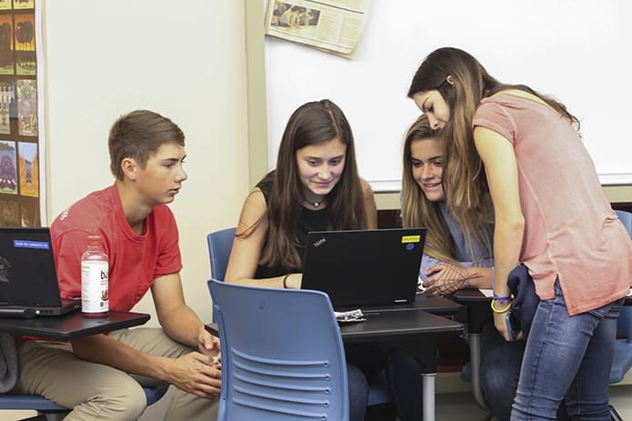 (L-r) Marist school sophomores Matthew Larkin, Caroline Doran, Jenna Monnin and Kylie Gagnon work on editing their human trafficking public service announcement. Photo By Michael Alexander