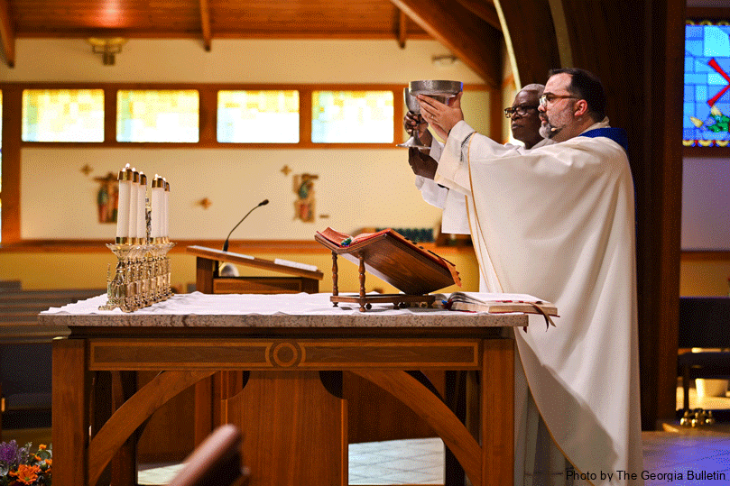 Father Jack Knight, pastor of St. John Vianney Church, with Deacon Erick Simeus serving, celebrated the first sensory Mass at the parish on Sept. 15. The parish plans to celebrate its next sensory Mass on Dec. 1. In addition to monthly support meetings, the church recently launched a Special Needs Youth Group that hosts community events.  Photo by Julianna Leopold