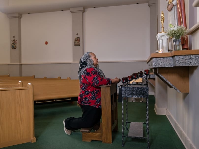 Salome Lambert of the Seven Sisters Apostolate prays for her pastor, Father Juan Areiza, in the sanctuary at St. Pius X Church in Conyers. Photo by Johnathon Kelso