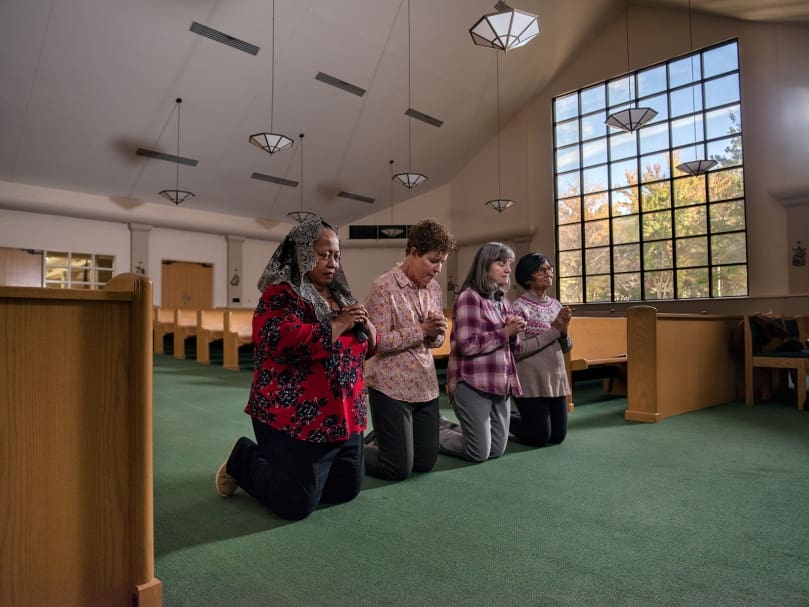 Members of the Seven Sisters Apostolate pray for their Pastor, Father Juan Areiza, in the sanctuary at St. Pius X Catholic Church in Conyers. From left to right, Salome Lambert, Beth Gowasack, Brenda Stoll, and Verena D'mellow. Photo by Johnathon Kelso
