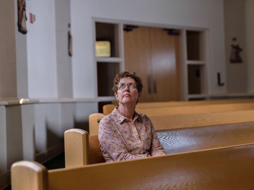 Beth Gowasack of the Seven Sisters Apostolate prays for her pastor, Father Juan Areiza, in the sanctuary at St. Pius X Catholic Church. Photo by Johnathon Kelso
