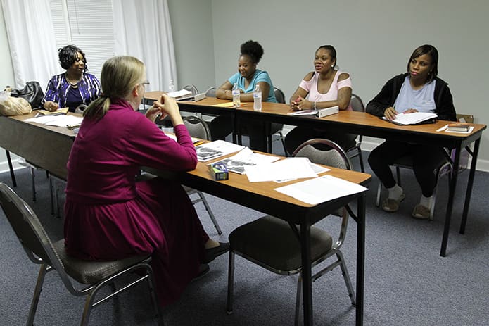 (Clockwise, from foreground left) Carol Buffum and Dr. JoAnn Hayward conduct a Wednesday evening life skills class for expectant mothers Jessica Potts, Charlene James and Takneesha Copeland. Photo By Michael Alexander
