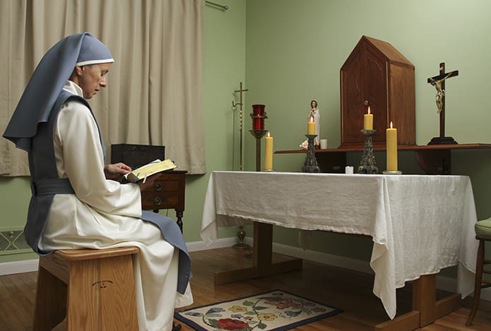 Sister Mary Beatrice Raphael (formerly Bette Potter, M.D.) sits before the altar and tabernacle in her Conyers home chapel, where she spends time in prayer during various hours of the day. Photo By Michael Alexander