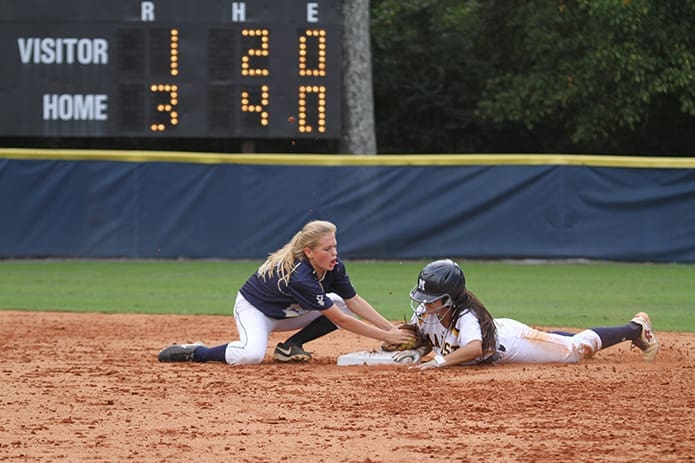 Teran, right, is safe as Bartles unsuccessfully applies the tag in time. Marist defeated St. Pius 9-2 on Sept. 22 to remain undefeated in region play. Photo By Michael Alexander