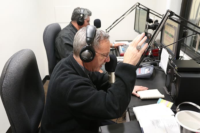 Bishop Luis R. Zarama blesses the radio studio over the air during the afternoon broadcast of the Spanish Catholic radio program, âNuestra Feâ (Our Faith). Photo By Michael Alexander