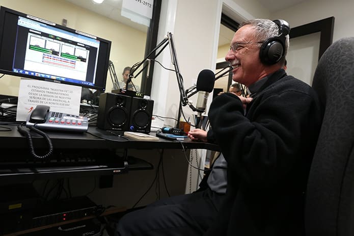 Bishop Luis R. Zarama shares a laugh with the radio crew at the program’s conclusion, Oct. 31. Photo By Michael Alexander