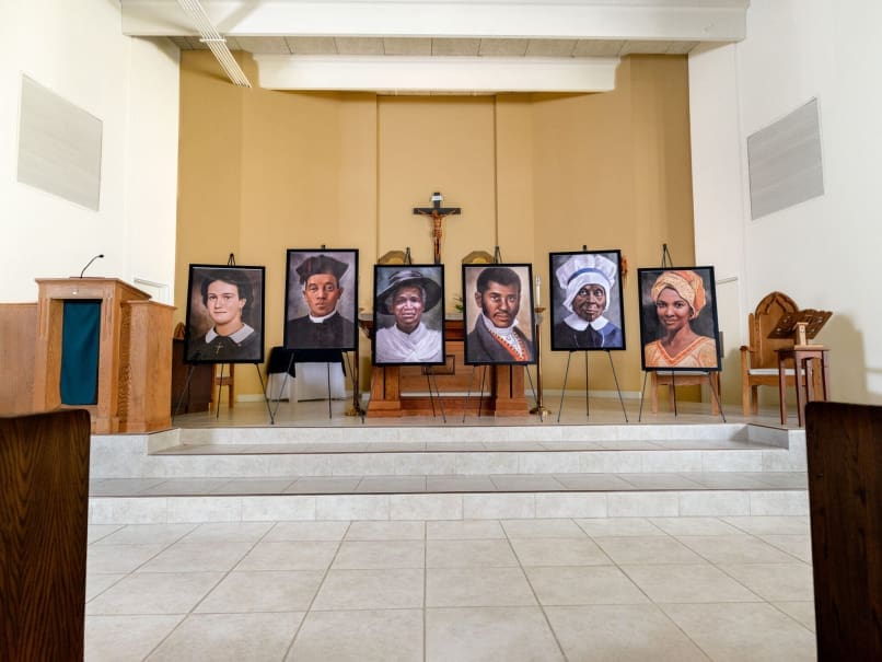 Portaits of the Black American candidates for sainthood are presented at the altar of Sts. Peter and Paul church before the Sojourning On the Road to Sainthood event. Photo by Johnathon Kelso