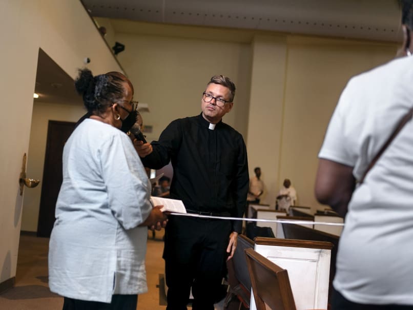 Father Bryan Small, pastor of Sts. Peter and Paul Church in Decatur, prays a living rosary with the community during the Sojourning On the Road to Sainthood event. Photo by Johnathon Kelso