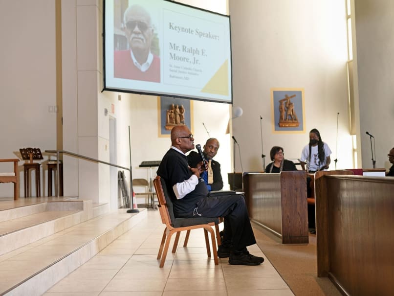 Guest lecturer Ralph Moore Jr. speaks at Sts. Peter and Paul Church during the Sojourning On the Road to Sainthood event. Ashley Williams, director of Black Catholic Affairs for the Archdiocese of Atlanta, listens to Moore's remarks. Photo by Johnathon Kelso