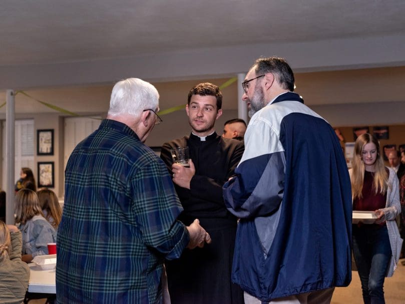 Father Gregory Tipton, pastor of St. Aelred Church in Bishop, talks with parishioners at a Friday evening fish fry. Photo by Johnathon Kelso