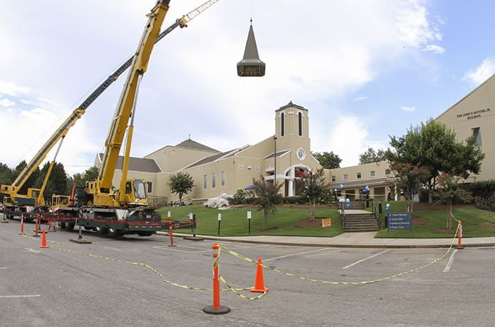 Heaton Erecting, Inc. crane operator Robbie Siniard lifts the cupula in place over the steeple at St. Andrew Church, Roswell, during the afternoon of Aug. 19. Photo By Michael Alexander