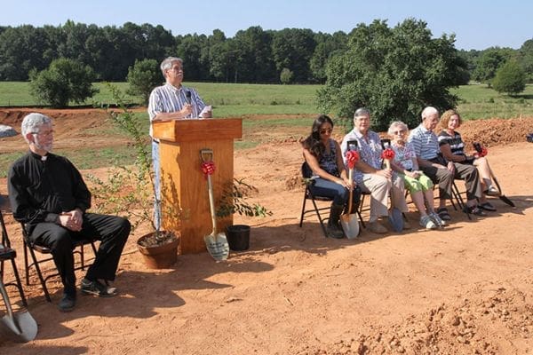 St. Anna Church capitol campaign co-chair Ed Reinagel makes a presentation during the September 7 groundbreaking ceremony. Seated across the front and listening are (l-r) Father Daniel Toof, pastor, Daniela Wieczorek, the other capitol campaign co-chair, Vickie Chancey, Catherine and Dan Melton, and their daughter Carol Cernogorsky. The Meltons were on hand for St. Annaâs first Mass at the East Spring Street location in Monroe. Chancey and Cernogorsky also attended as children. Photo By Michael Alexander