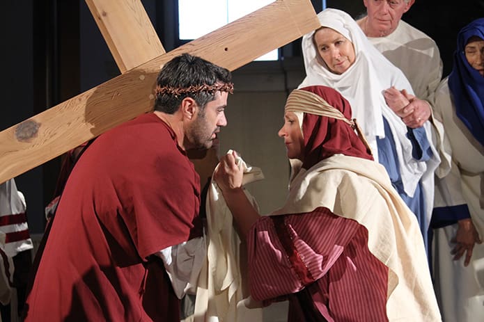 Veronica (Nancy Early), right, steps out of the crowd to gently wipe the face of Jesus.