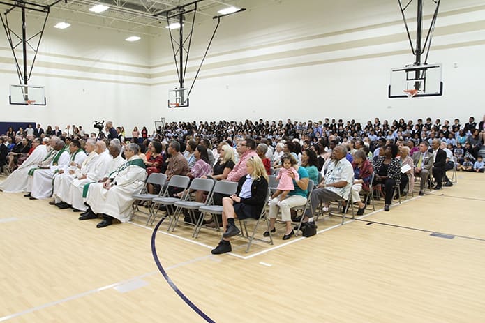 Hundreds of people fill the new Enrichment Center gymnasium at St. John the Evangelist School, Hapeville, for a program to mark its opening. Photo By Michael Alexander