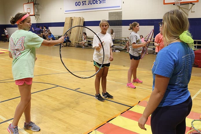 Students, l-r, Kate Ueblacker, Molly Jannetta and Kate Gillett go over their hula-hoop act as instructor Taylor Byrnes looks on during the Sept. 8 rehearsal. Photo By Michael Alexander