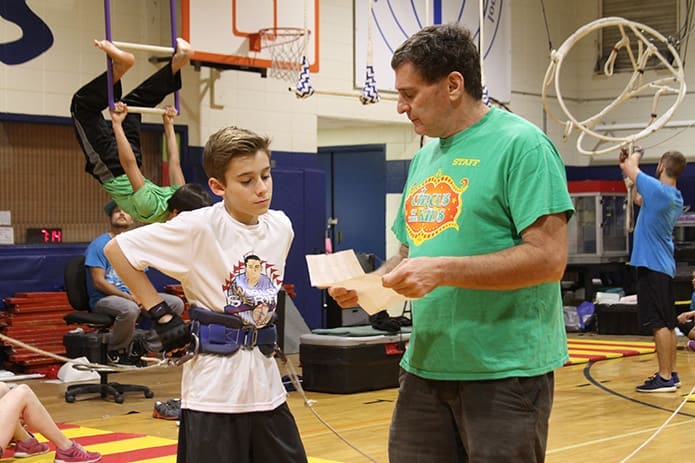 Circus of the Kids founder and Tallahassee, Fla. native Bruce Pheffer, right, goes over the swinging trapeze routine with St. Jude seventh-grader Evan Sitzmann. Photo By Michael Alexander