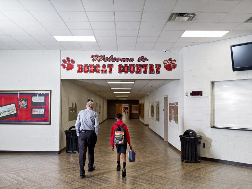 A teacher walks with a student at St. Mary's Academy in Fayetteville on the first day of the new school year. Photo by Johnathon Kelso