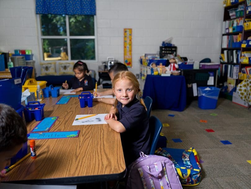 Kindergarten student Claire Schilling takes a break from drawing on the first day of school at St. Mary's Academy in Fayetteville, the new pre-K-12 archdiocesan school. The school, which combined the communities of Our Lady of Victory School in Tyrone and Our Lady of Mercy High School, opened Aug. 8.  Photo by Johnathon Kelso
